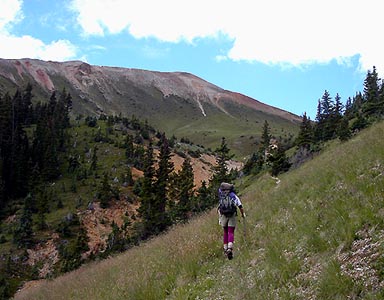 Jennifer on the trail to the Irwin Mine, with Anvil Mountain waiting above